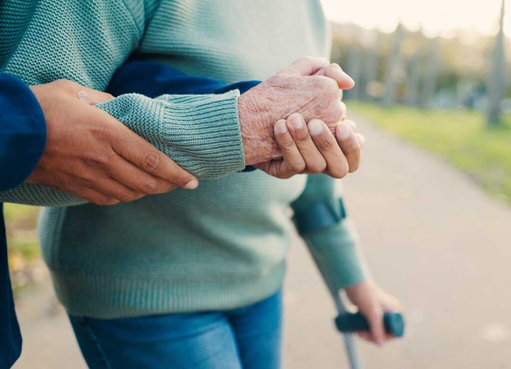 Family member reviews a resident’s care documents with an assisted living staff member at a quiet table.
